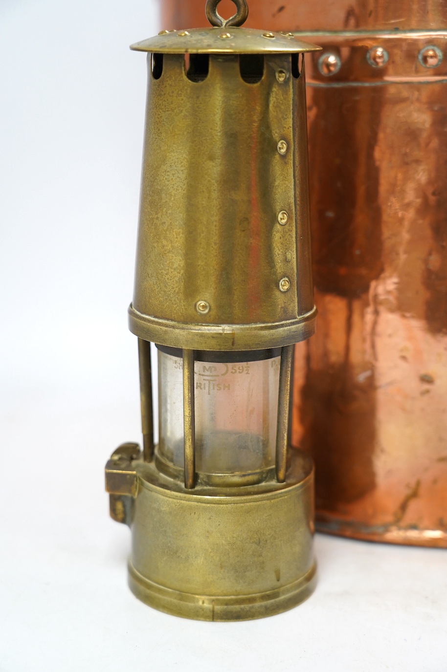 A brass handled copper coal bin and The Protector brass miner’s lamp, coal bin 30cm high. Condition - coal bin has some minor dents, miner’s lamp good